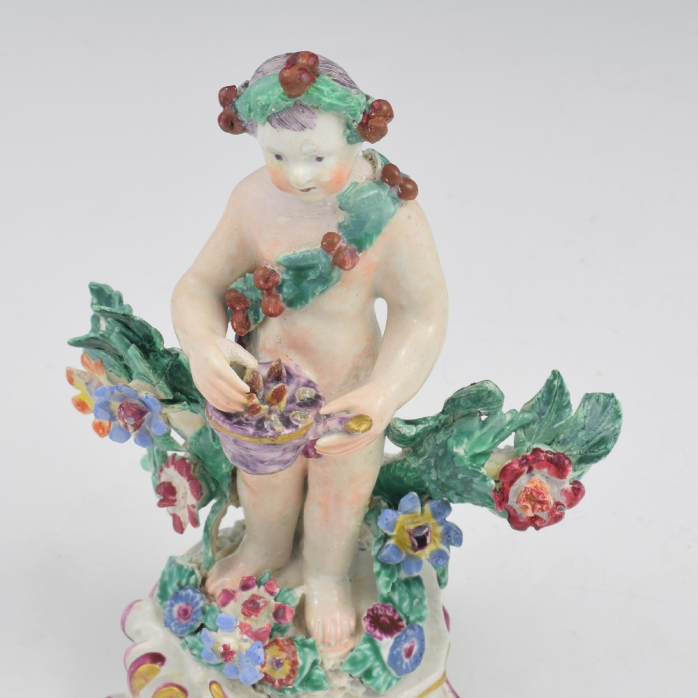 A set of four 18th-century Bow soft-paste porcelain figures representing the seasons, depicting putti on rococo scroll bases with colourful floral bocage. View XXVII