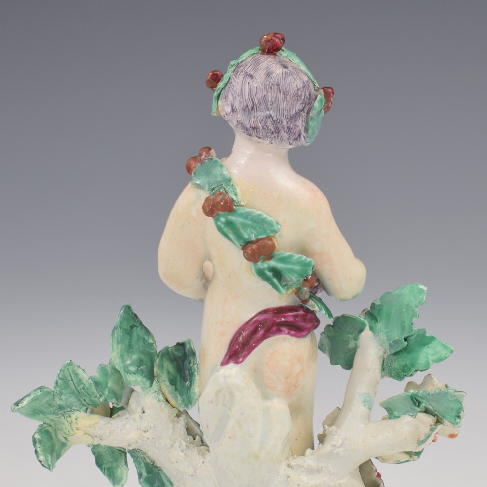 A set of four 18th-century Bow soft-paste porcelain figures representing the seasons, depicting putti on rococo scroll bases with colourful floral bocage. View XXVIII