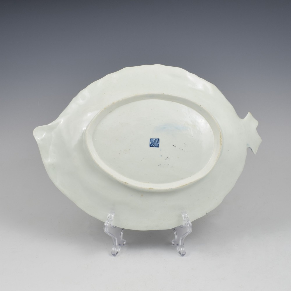 A leaf-shaped eighteenth-century Worcester porcelain dish decorated with a cobalt scale blue ground, gilded rococo reserves, floral sprays, and a central butterfly. View II