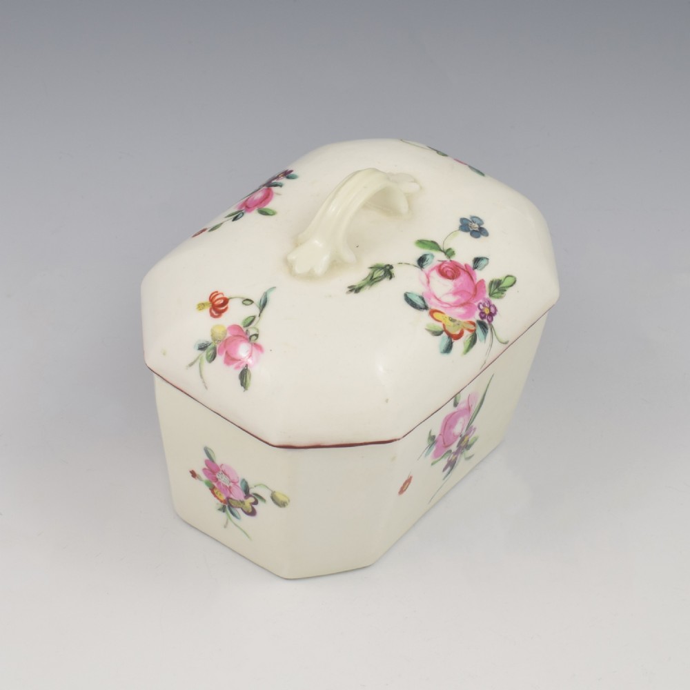 An 18th-century off-white porcelain butter tub with a fitted cover, top handle, and hand-painted floral motifs. View III