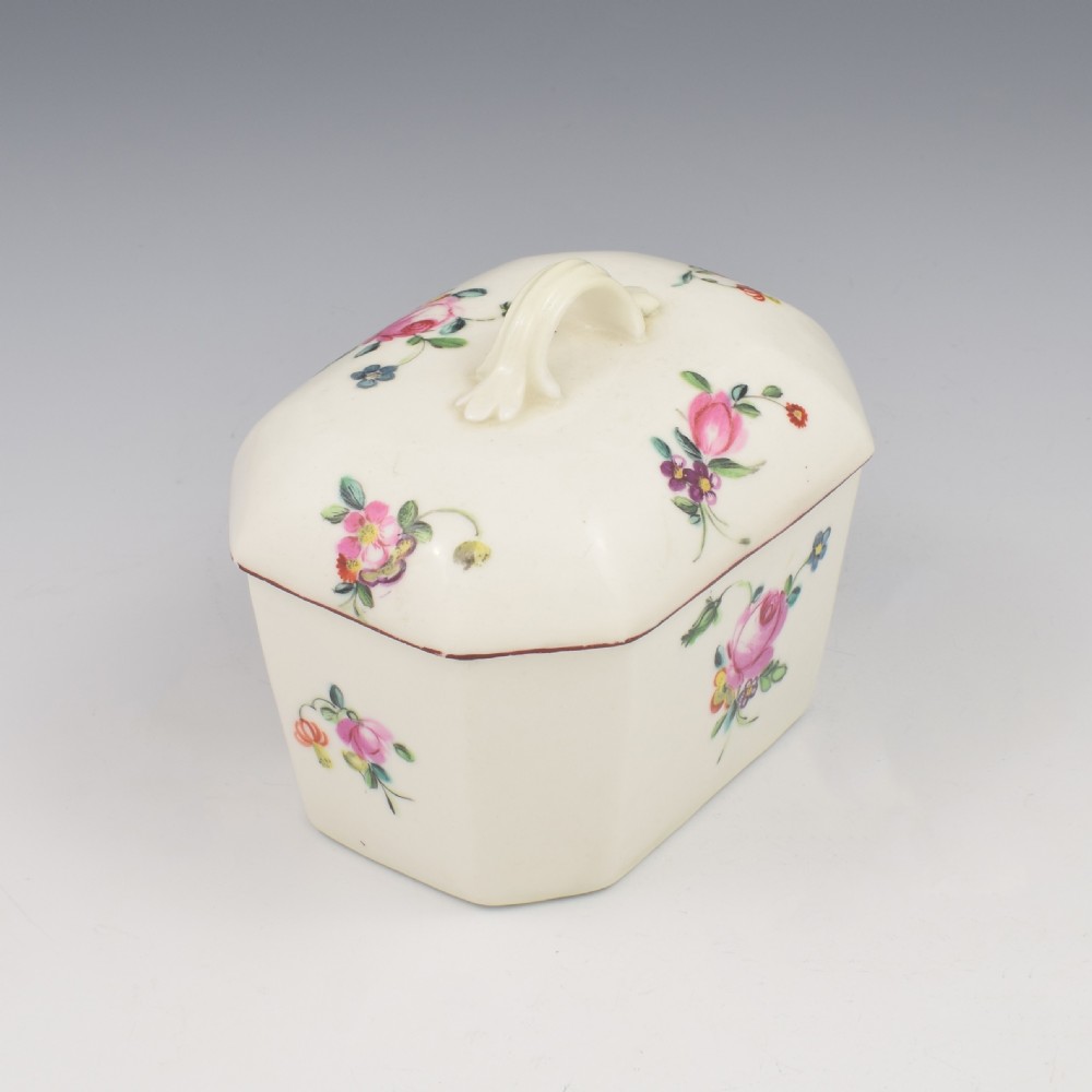 An 18th-century off-white porcelain butter tub with a fitted cover, top handle, and hand-painted floral motifs. View IX