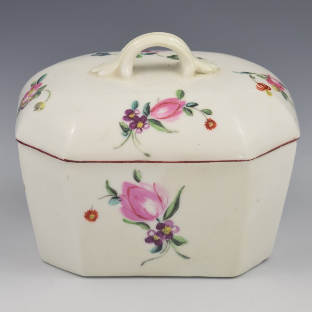 An 18th-century off-white porcelain butter tub with a fitted cover, top handle, and hand-painted floral motifs. View XIII