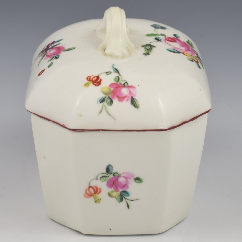 An 18th-century off-white porcelain butter tub with a fitted cover, top handle, and hand-painted floral motifs. View XIV