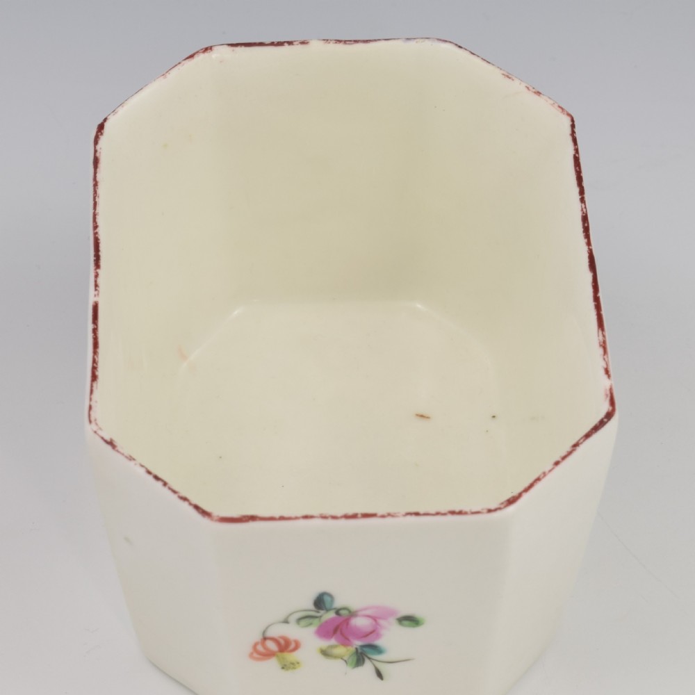 An 18th-century off-white porcelain butter tub with a fitted cover, top handle, and hand-painted floral motifs. View XXI