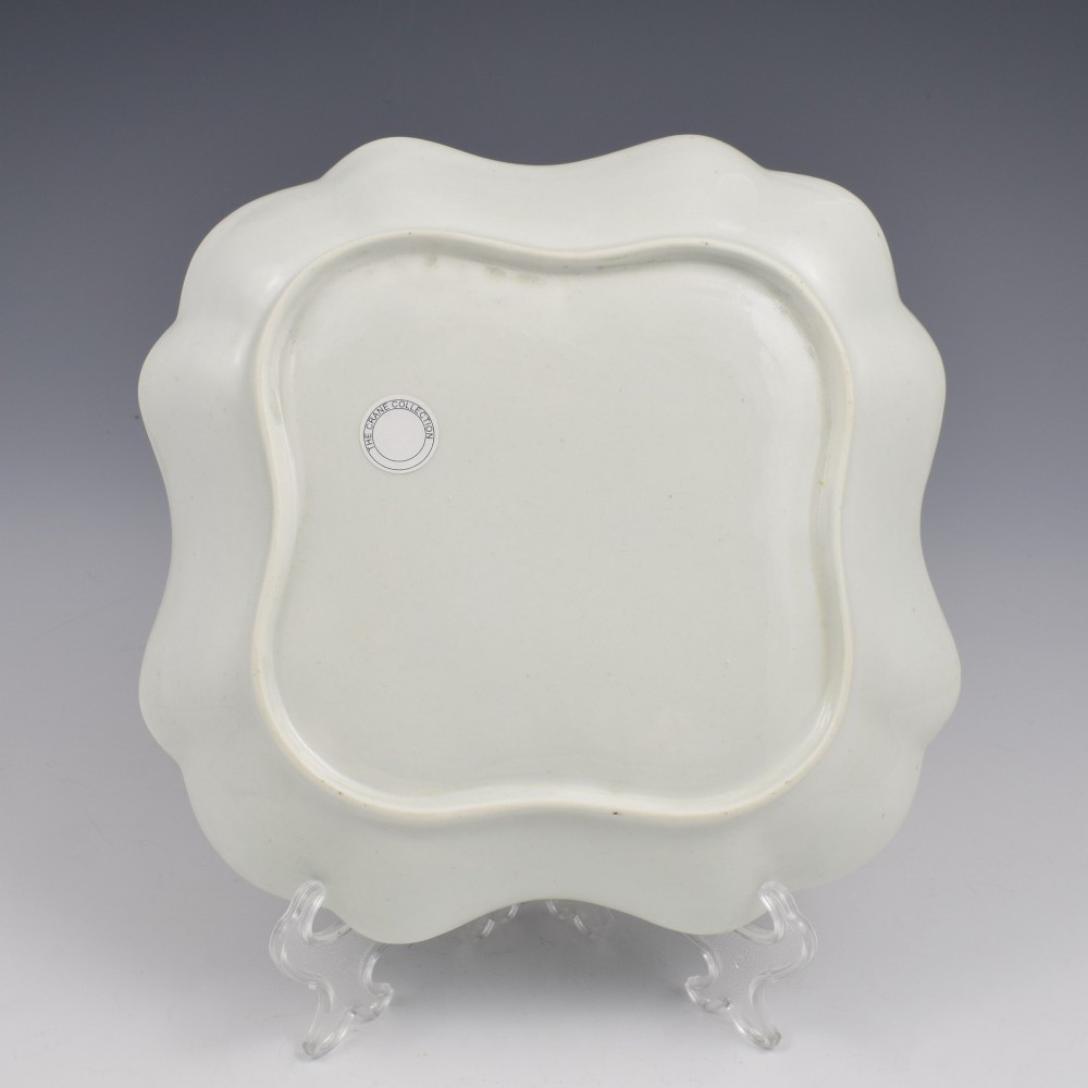 An eighteenth-century square lobed soft-paste porcelain dessert dish featuring hand-painted fruit sprays and a gilded rim. View V