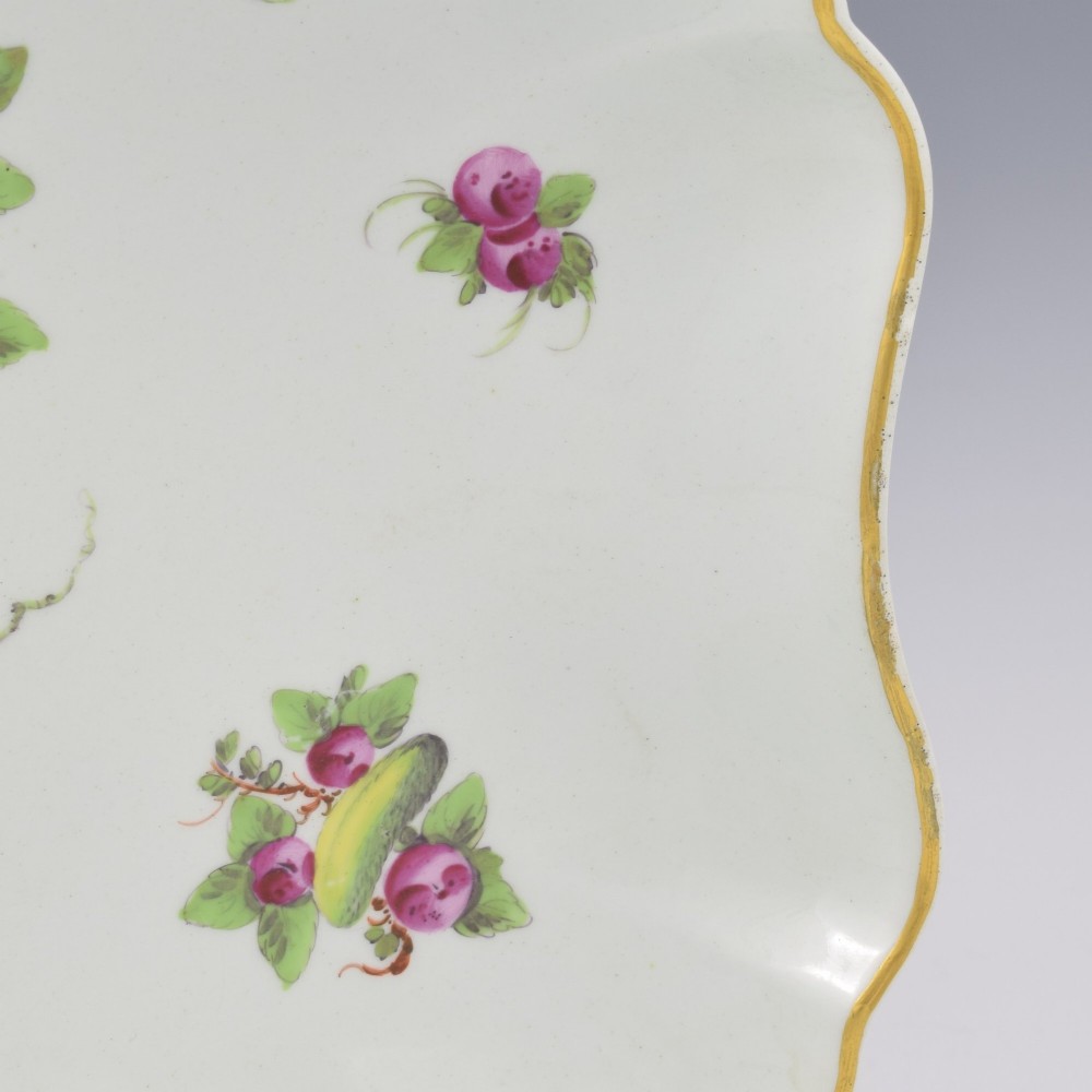 An eighteenth-century square lobed soft-paste porcelain dessert dish featuring hand-painted fruit sprays and a gilded rim. View VIII