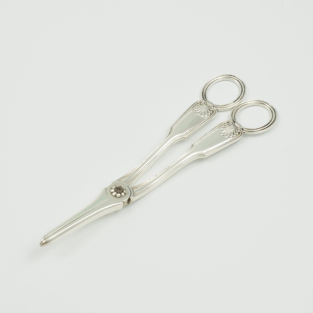A pair of late Victorian sterling silver grape scissors featuring shell motifs near the oval finger loops and molded handles. View III
