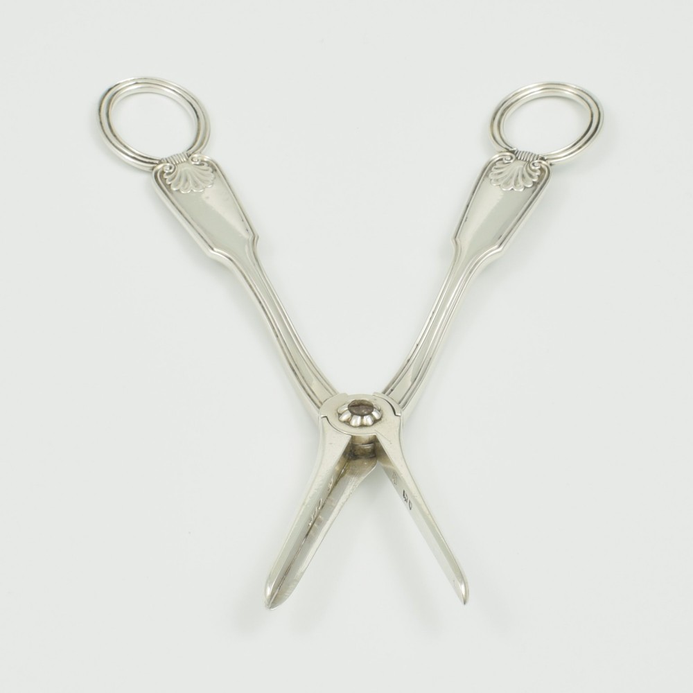 A pair of late Victorian sterling silver grape scissors featuring shell motifs near the oval finger loops and molded handles. View VIII