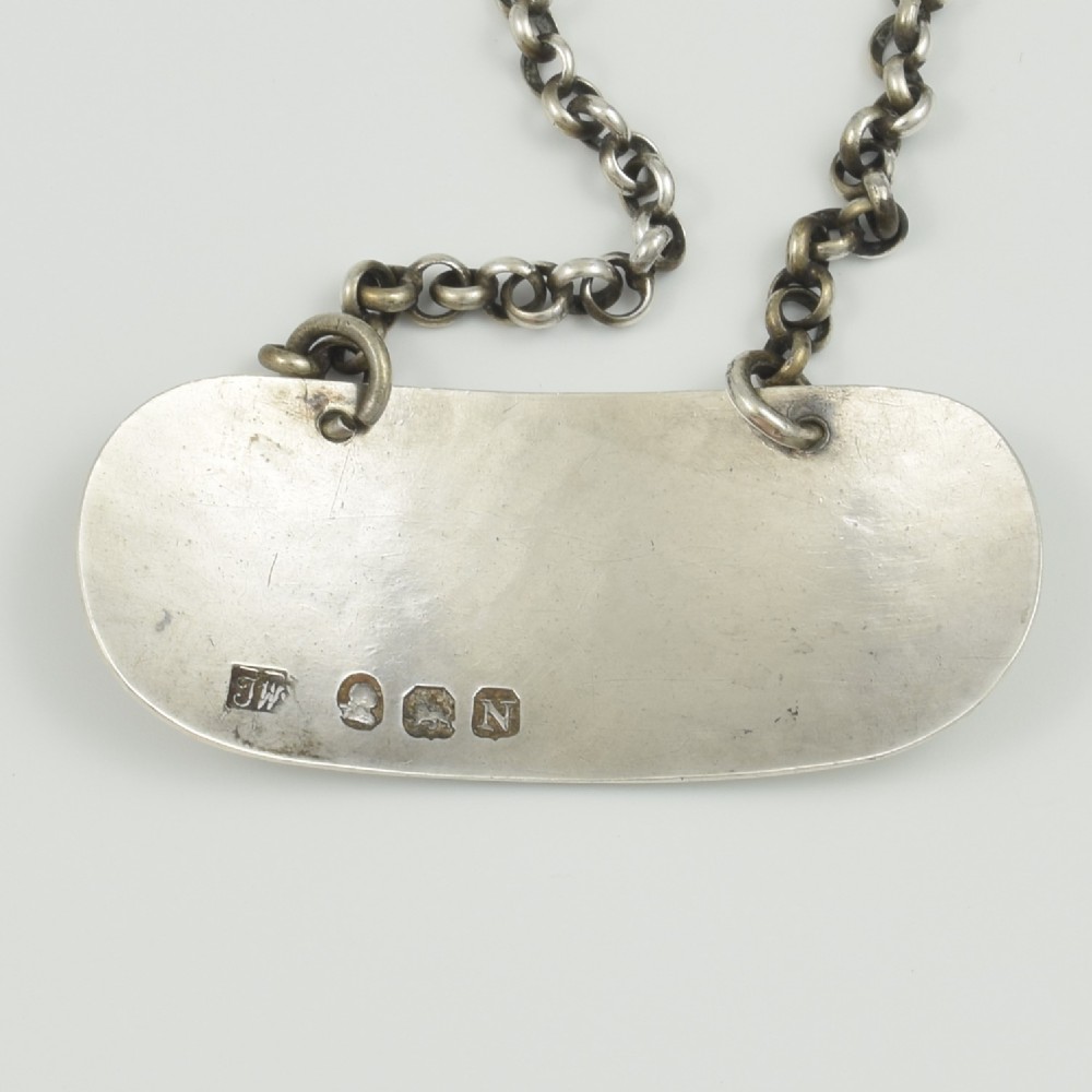 A Georgian sterling silver oblong decanter label engraved with the word CLARET and suspended from a fine silver chain. View III