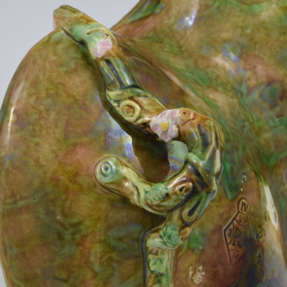 A Victorian George Jones majolica strawberry basket featuring double compartments decorated with relief leaves, pink blossoms, and an overarching branch handle in green, brown, and turquoise glazes. View XVI
