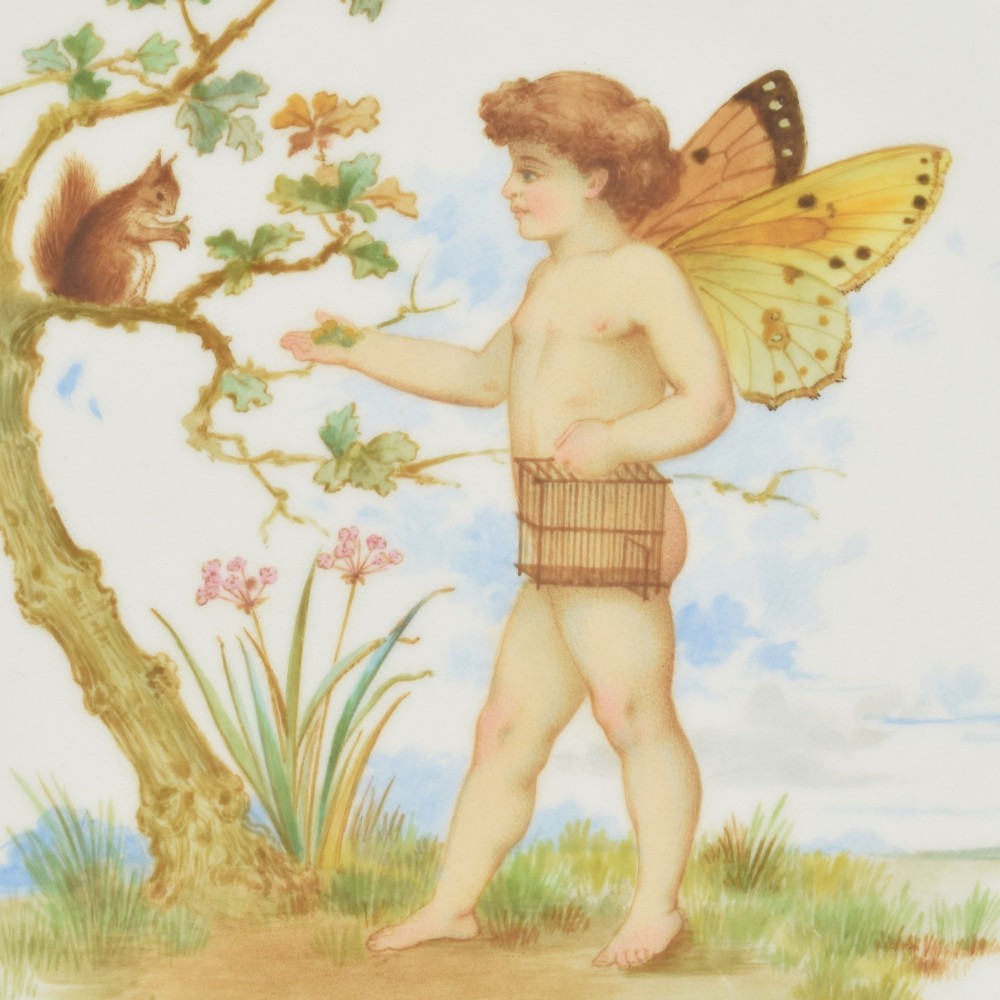 An antique round Minton porcelain cabinet plate featuring a reticulated gilt rim with turquoise trim and a hand-painted central illustration of a winged fairy near a squirrel in an oak tree. View III