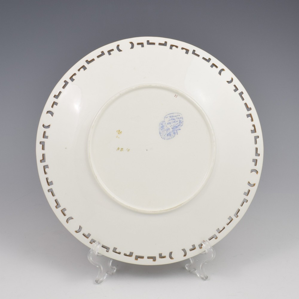 An antique round Minton porcelain cabinet plate featuring a reticulated gilt rim with turquoise trim and a hand-painted central illustration of a winged fairy near a squirrel in an oak tree. View XI