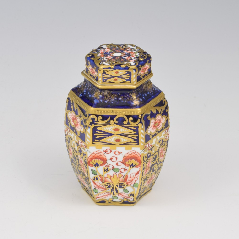 A Victorian hexagonal porcelain tea canister decorated in cobalt blue, iron red, and gilt hand-painted floral motifs with a fitted lid. View II