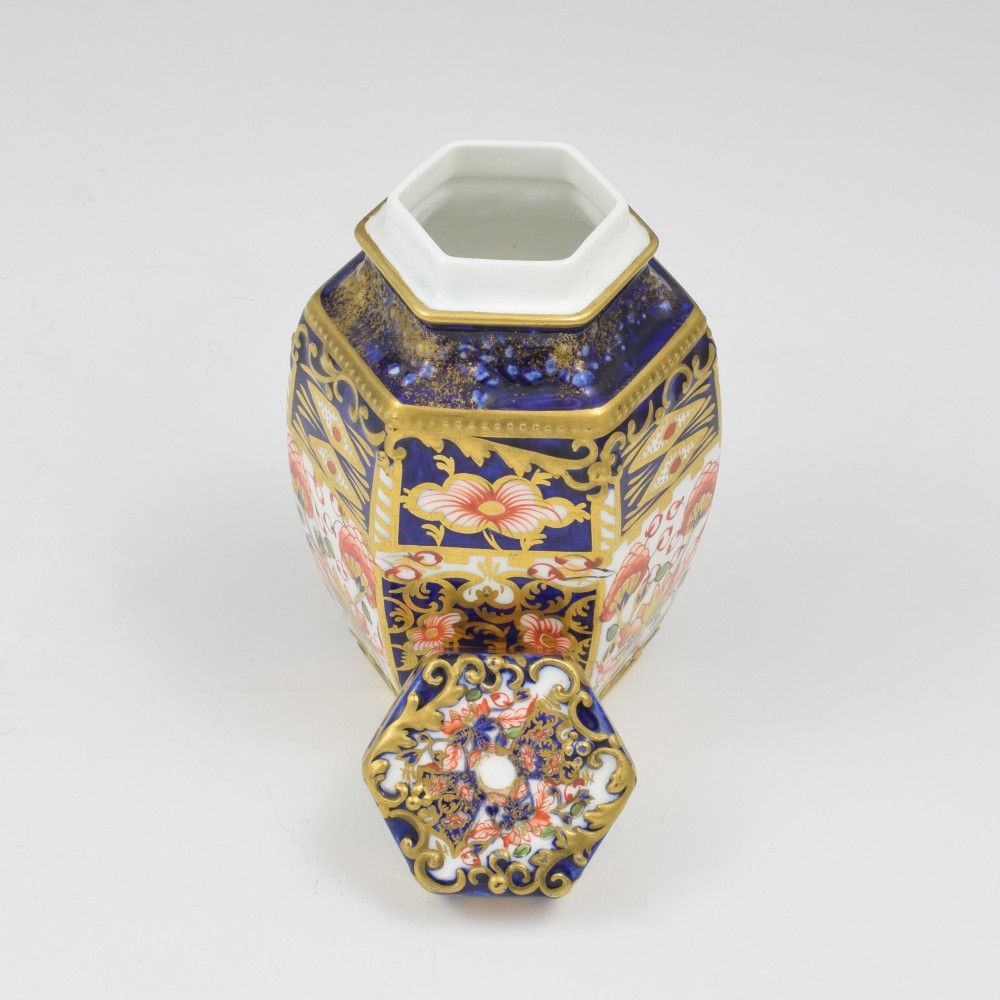 A Victorian hexagonal porcelain tea canister decorated in cobalt blue, iron red, and gilt hand-painted floral motifs with a fitted lid. View VI