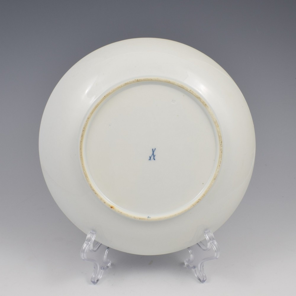 A circular white porcelain dish painted with detailed birds perched on a branch surrounded by small insects and framed by a blue foliate border. View VI