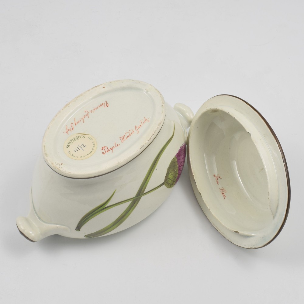 A Georgian cream pearlware lidded sauce tureen hand painted with botanical flowers and featuring scroll handles and a scroll finial. View X