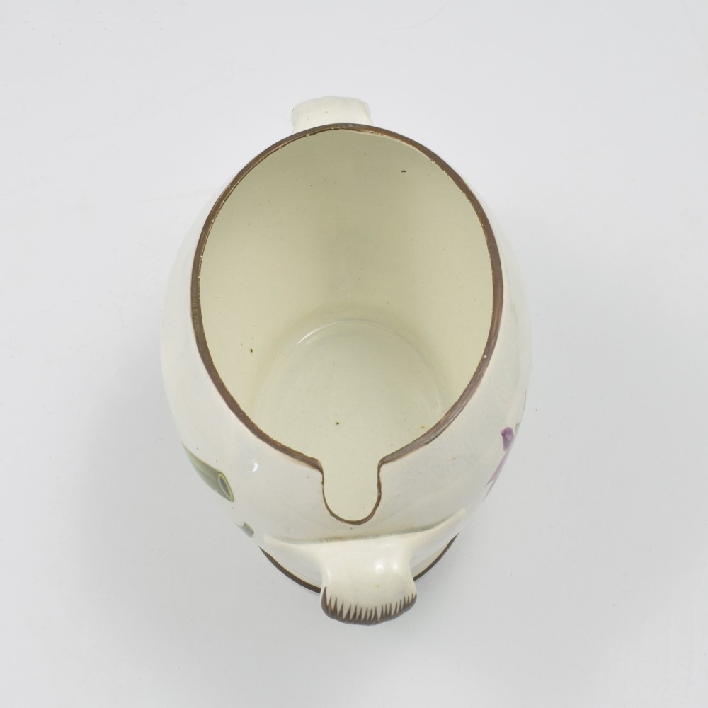 A Georgian cream pearlware lidded sauce tureen hand painted with botanical flowers and featuring scroll handles and a scroll finial. View XII