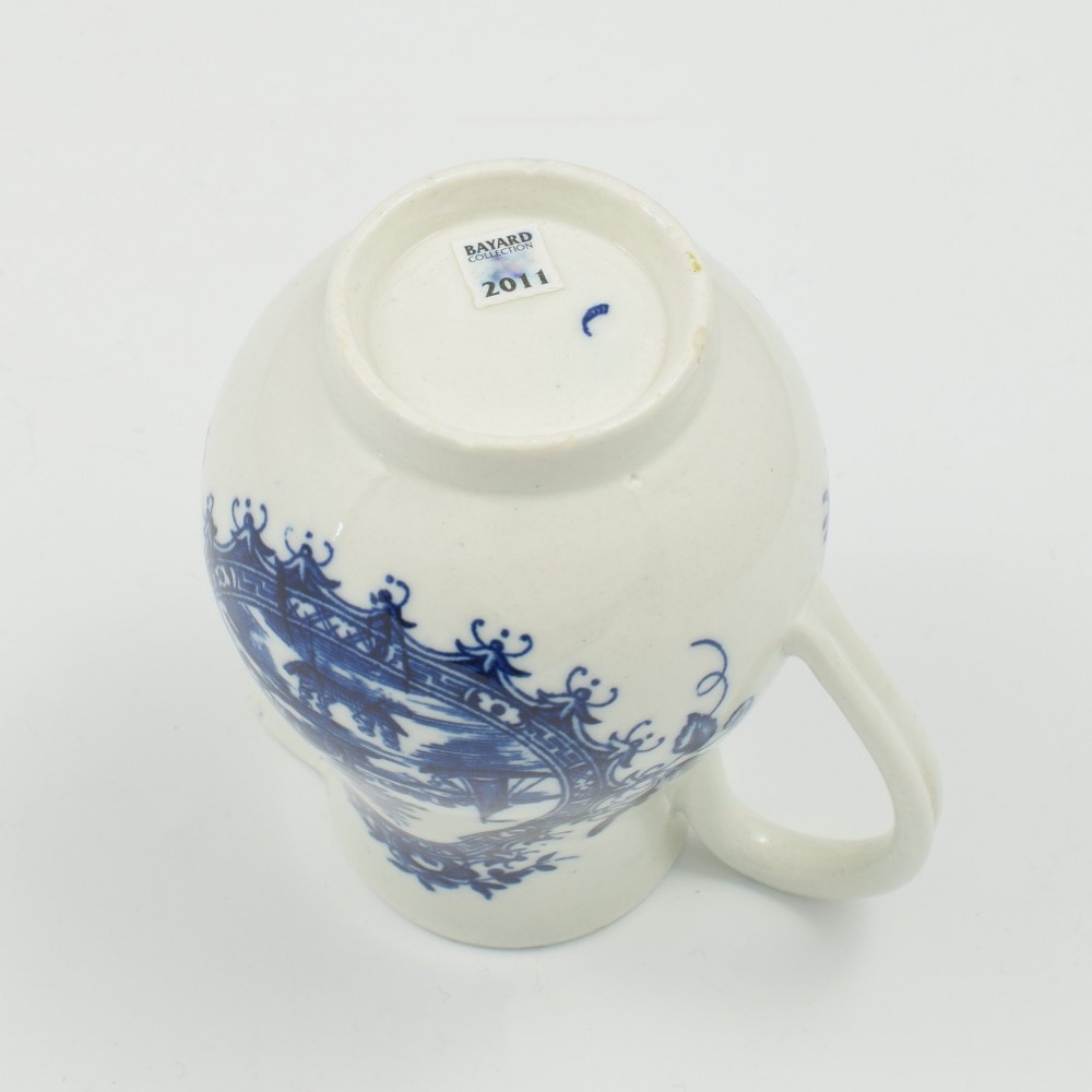 A Georgian blue and white soft-paste porcelain cream jug decorated with an underglaze landscape print in a cartouche frame. View VII