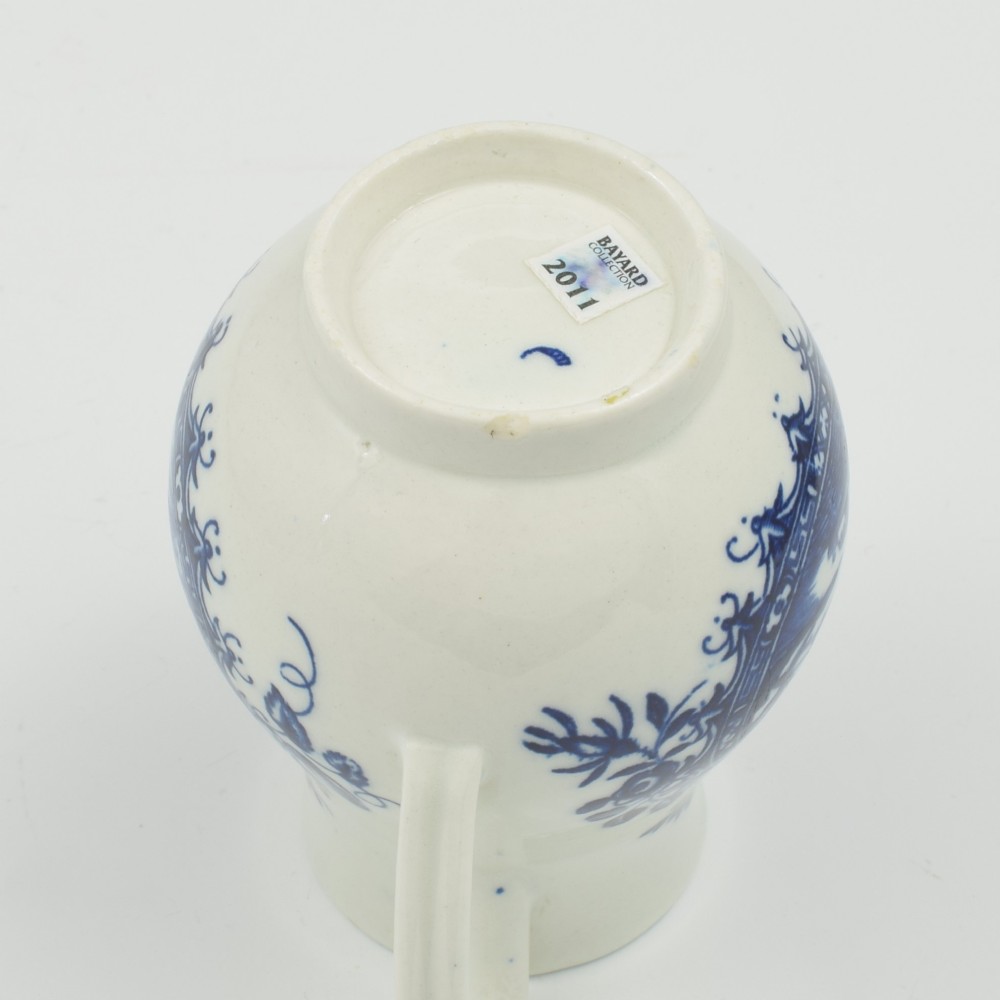 A Georgian blue and white soft-paste porcelain cream jug decorated with an underglaze landscape print in a cartouche frame. View VIII