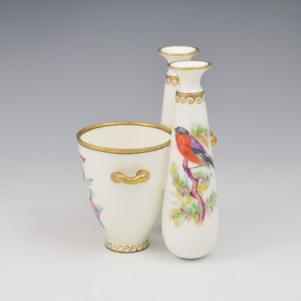 A Victorian white porcelain triple vase featuring three connected vessels decorated with hand-painted birds and gilt trim. View III