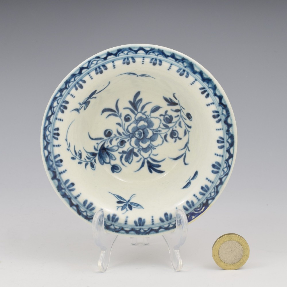 An 18th-century First Period Worcester circular porcelain patty pan featuring underglaze blue peony motifs and a patterned rim. View II