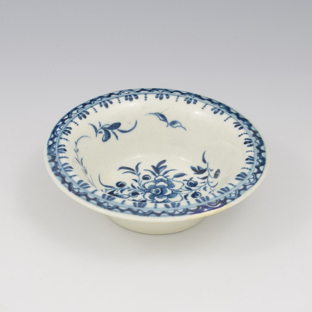 An 18th-century First Period Worcester circular porcelain patty pan featuring underglaze blue peony motifs and a patterned rim. View III