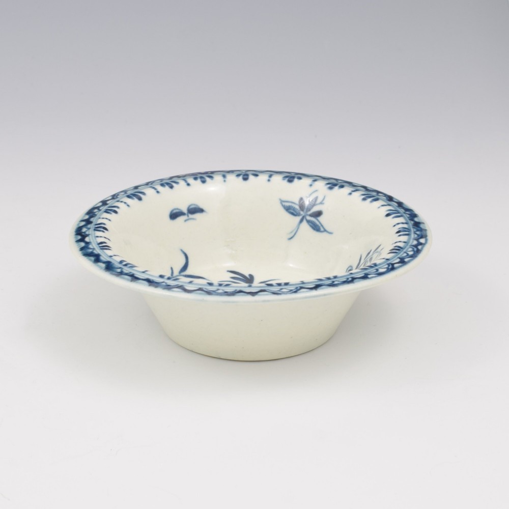 An 18th-century First Period Worcester circular porcelain patty pan featuring underglaze blue peony motifs and a patterned rim. View IV