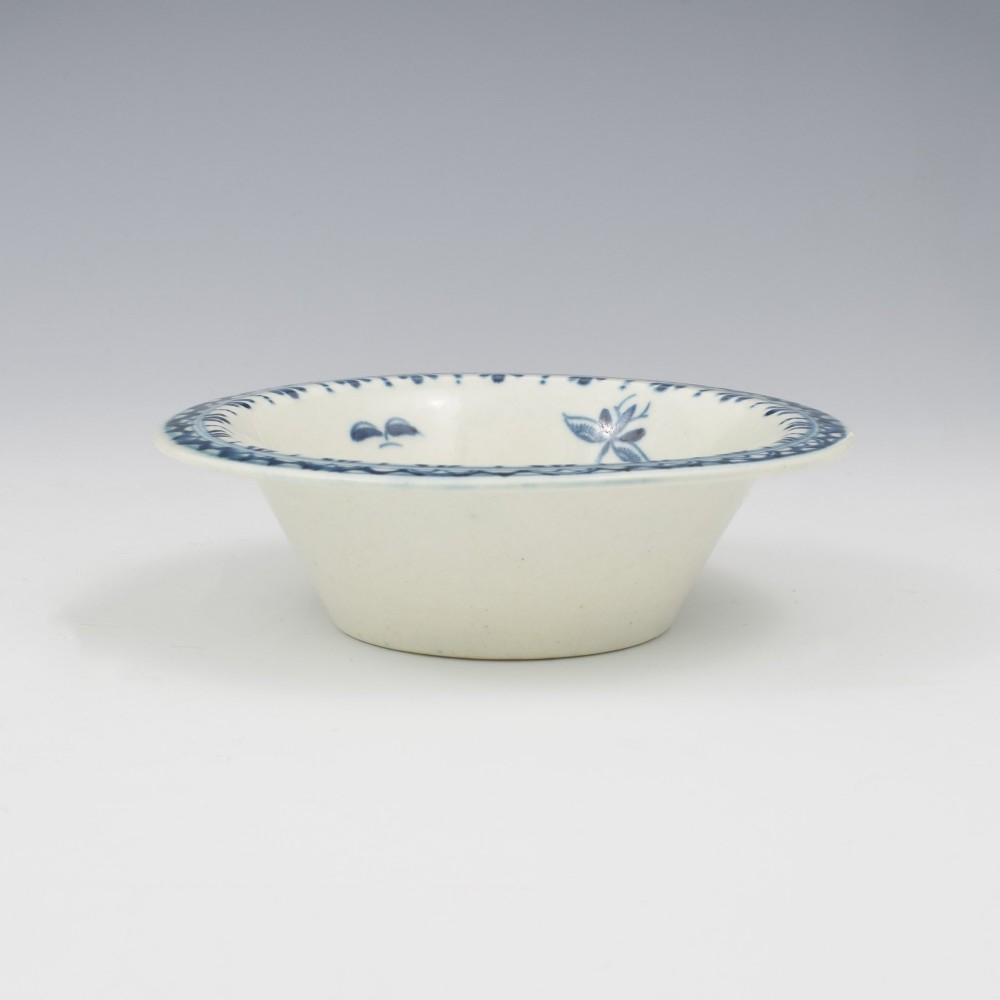 An 18th-century First Period Worcester circular porcelain patty pan featuring underglaze blue peony motifs and a patterned rim. View V