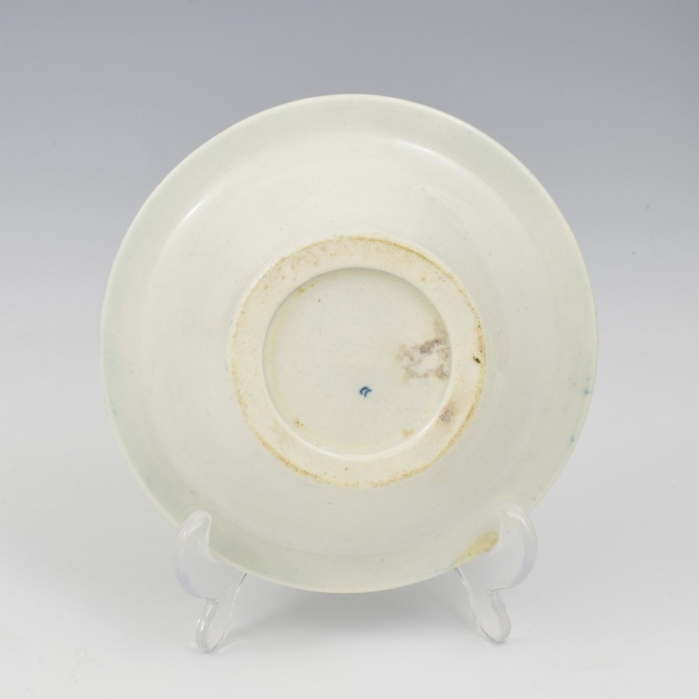 An 18th-century First Period Worcester circular porcelain patty pan featuring underglaze blue peony motifs and a patterned rim. View VI