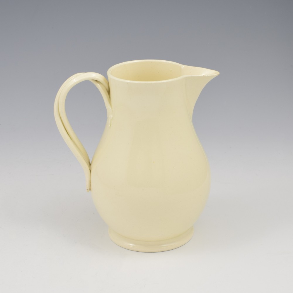 An 18th-century creamware hot water jug featuring a baluster-shaped earthenware body, a fitted dome cover with a ball finial, and a loop handle. View XIII
