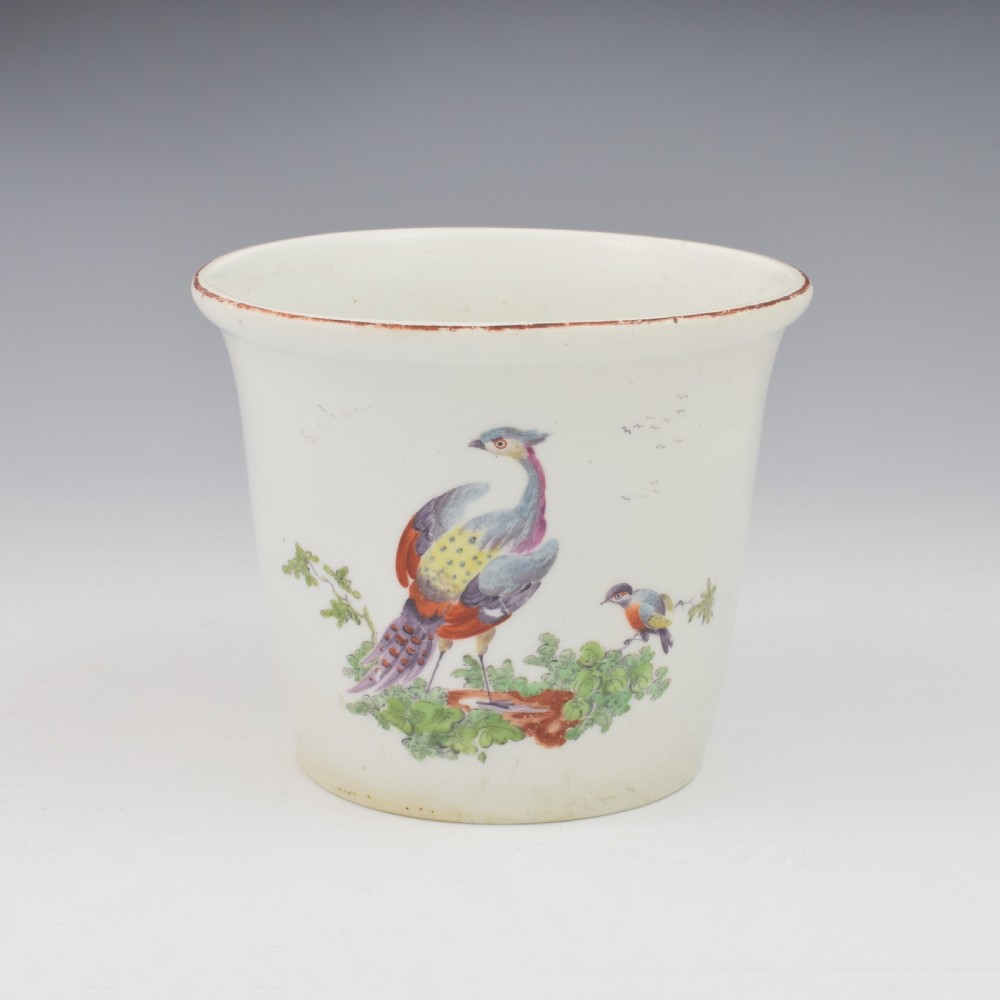An eighteenth-century white soft-paste porcelain flower pot and matching shallow stand, decorated with hand-painted polychrome birds and insects. View II