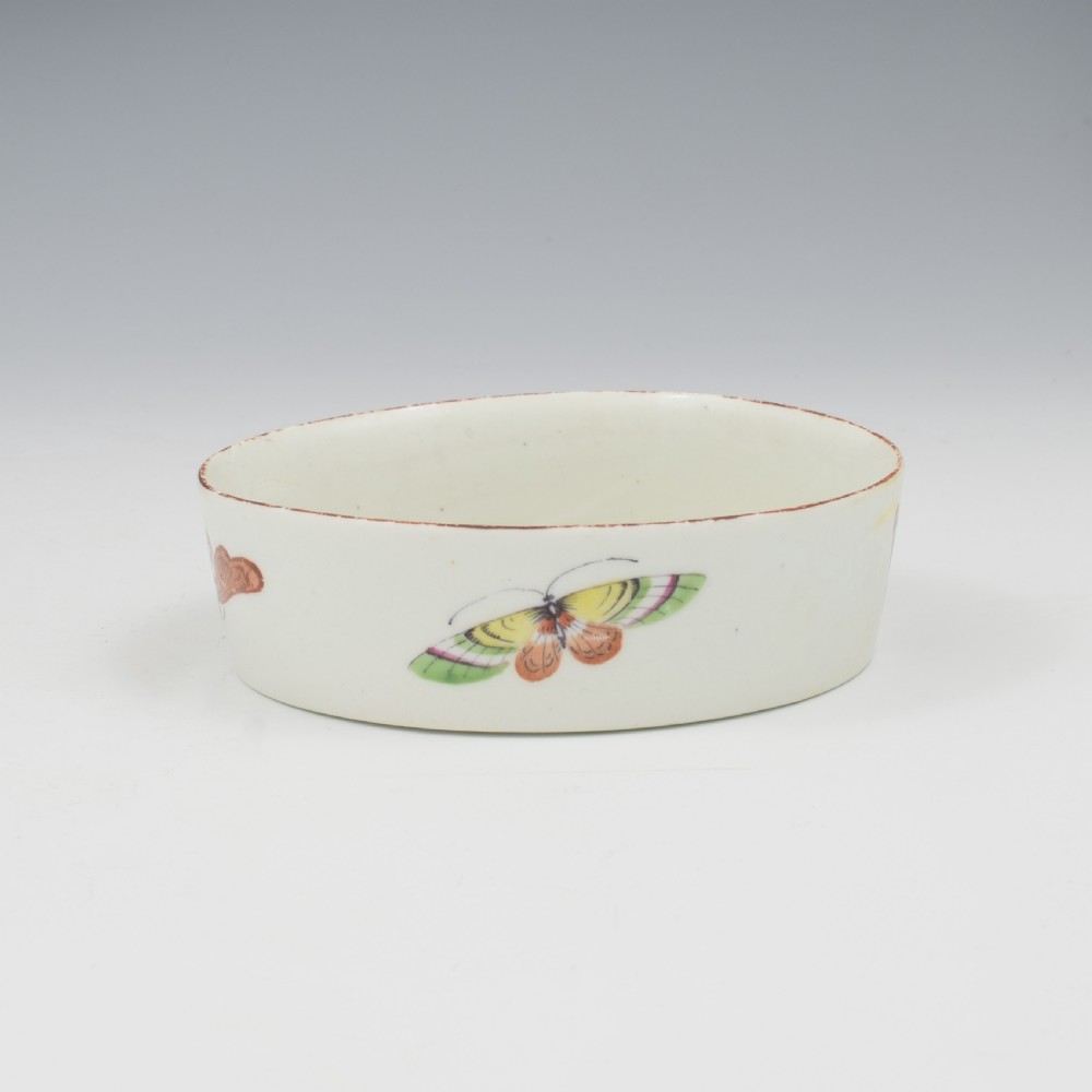 An eighteenth-century white soft-paste porcelain flower pot and matching shallow stand, decorated with hand-painted polychrome birds and insects. View X
