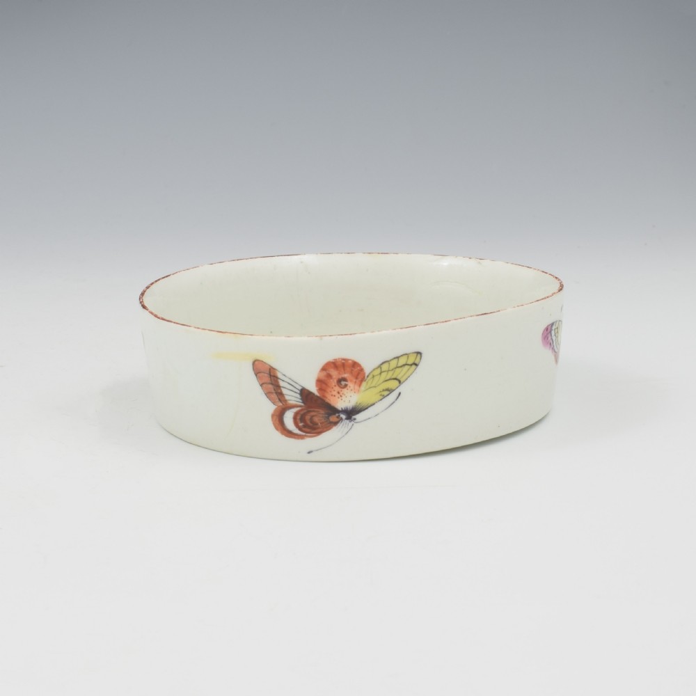 An eighteenth-century white soft-paste porcelain flower pot and matching shallow stand, decorated with hand-painted polychrome birds and insects. View XI