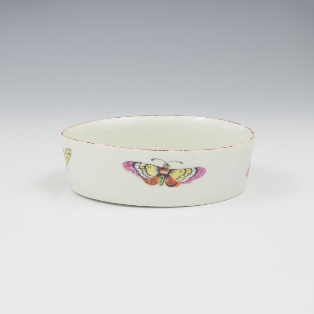 An eighteenth-century white soft-paste porcelain flower pot and matching shallow stand, decorated with hand-painted polychrome birds and insects. View XII