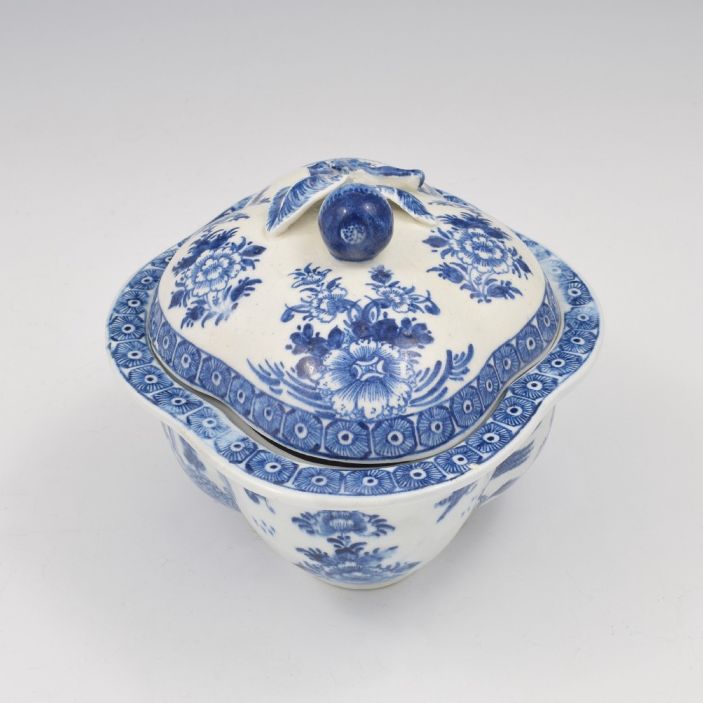 An eighteenth-century Derby soft-paste porcelain sauce tureen and cover featuring a quatrefoil shape, hand-painted blue and white Chinoiserie decoration, and a sculpted fruit handle on the lid. View VII