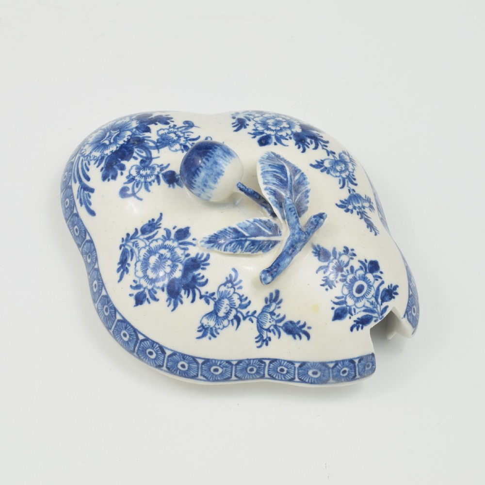 An eighteenth-century Derby soft-paste porcelain sauce tureen and cover featuring a quatrefoil shape, hand-painted blue and white Chinoiserie decoration, and a sculpted fruit handle on the lid. View IX