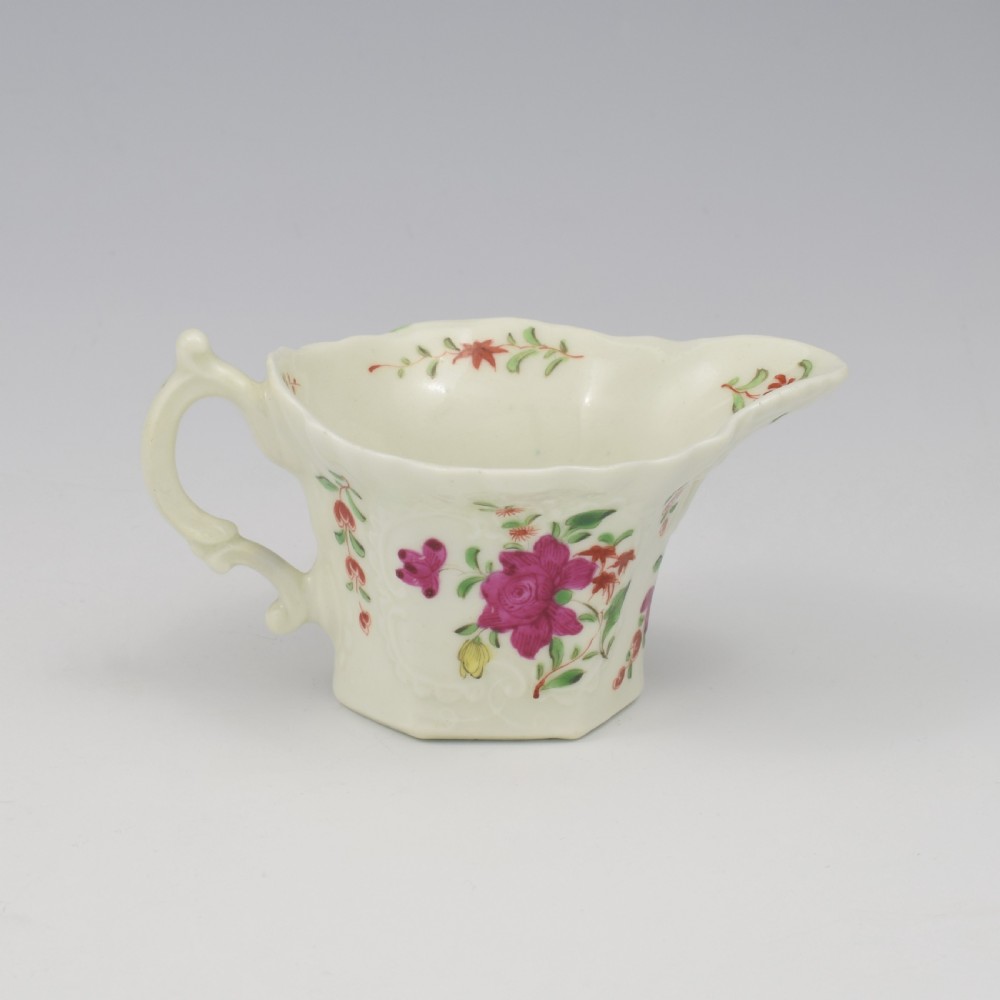 An 18th-century soft-paste porcelain hexagonal sauce boat featuring hand-painted pink floral sprays and a molded scroll handle. View VI