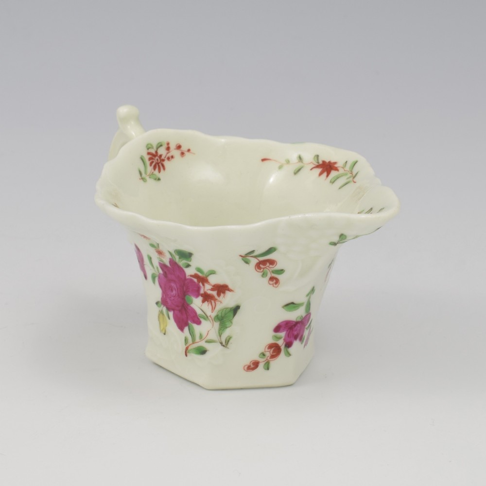 An 18th-century soft-paste porcelain hexagonal sauce boat featuring hand-painted pink floral sprays and a molded scroll handle. View VII