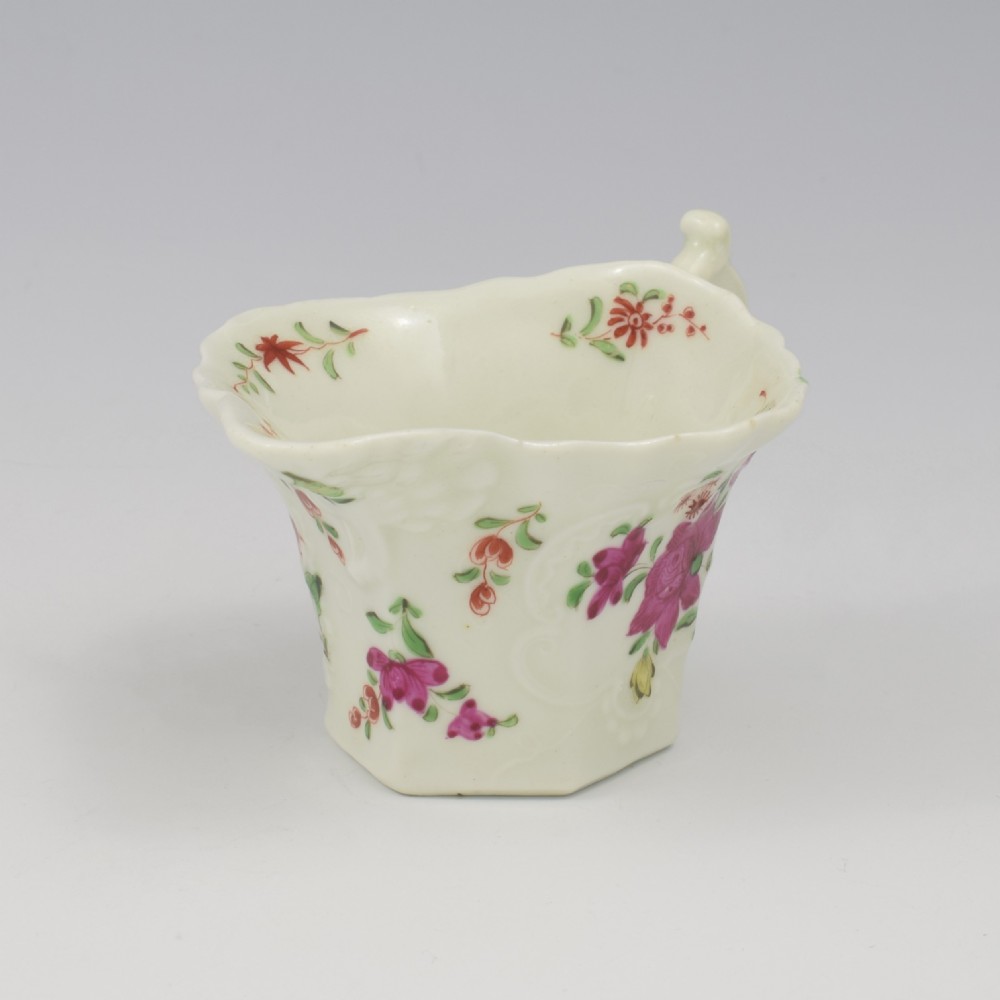 An 18th-century soft-paste porcelain hexagonal sauce boat featuring hand-painted pink floral sprays and a molded scroll handle. View VIII