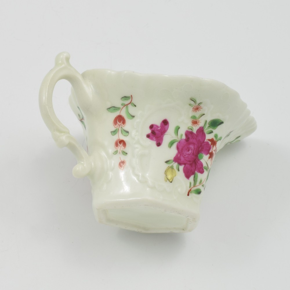 An 18th-century soft-paste porcelain hexagonal sauce boat featuring hand-painted pink floral sprays and a molded scroll handle. View XII