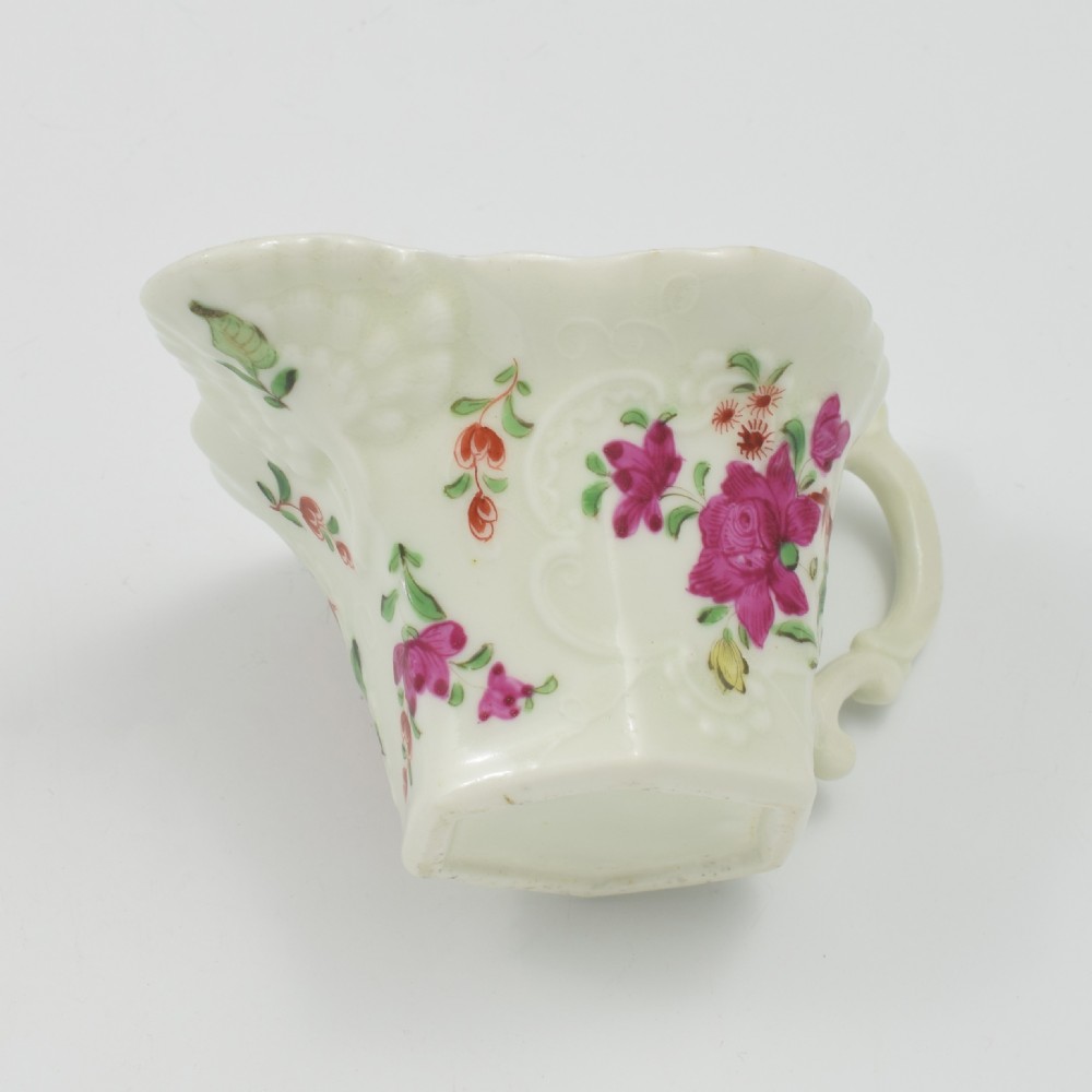 An 18th-century soft-paste porcelain hexagonal sauce boat featuring hand-painted pink floral sprays and a molded scroll handle. View XV