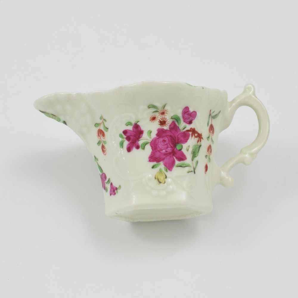 An 18th-century soft-paste porcelain hexagonal sauce boat featuring hand-painted pink floral sprays and a molded scroll handle. View XVII