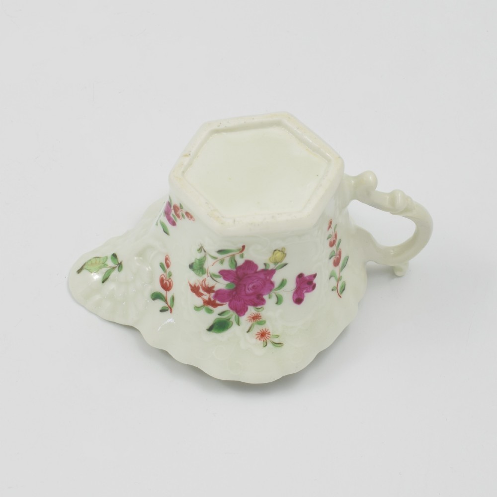 An 18th-century soft-paste porcelain hexagonal sauce boat featuring hand-painted pink floral sprays and a molded scroll handle. View XIX