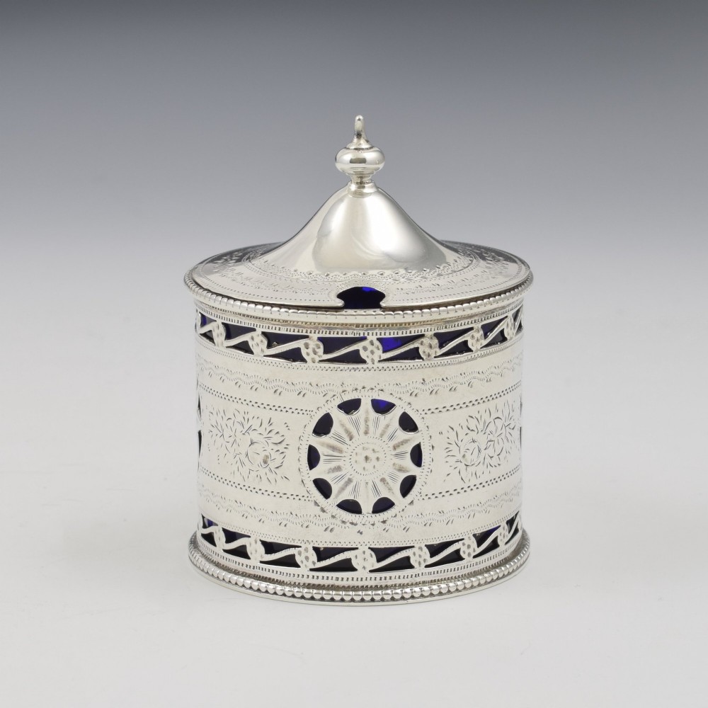 A Victorian silver drum mustard pot with pierced fretwork, bright-cut engraving, a hinged lid, and a cobalt blue glass liner. View III