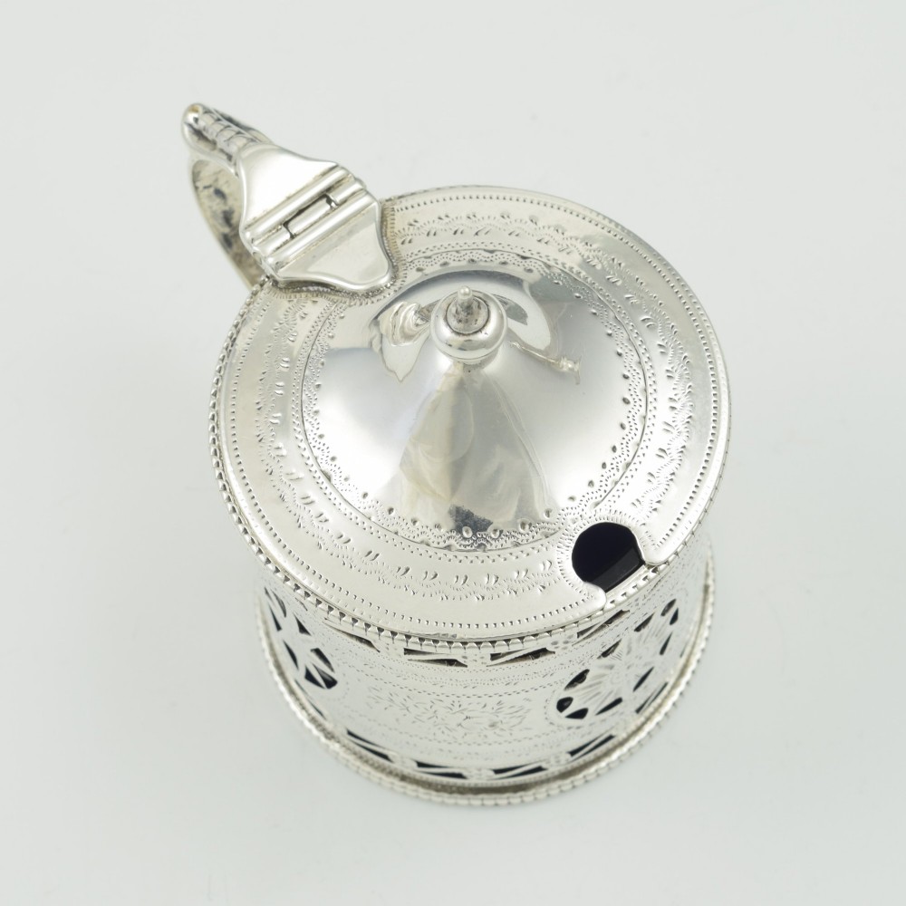 A Victorian silver drum mustard pot with pierced fretwork, bright-cut engraving, a hinged lid, and a cobalt blue glass liner. View VII
