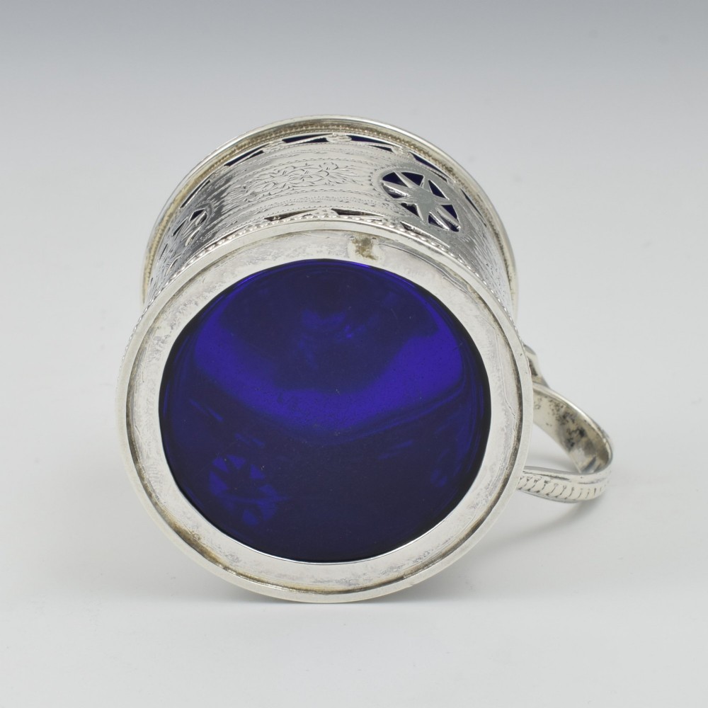 A Victorian silver drum mustard pot with pierced fretwork, bright-cut engraving, a hinged lid, and a cobalt blue glass liner. View XI