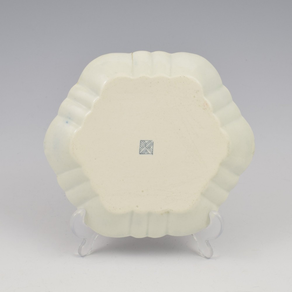 A scalloped Dr Wall Worcester porcelain teapot stand featuring a hand-painted blue scale ground, gilded rococo cartouches, and colourful Kakiemon-style floral motifs. View V
