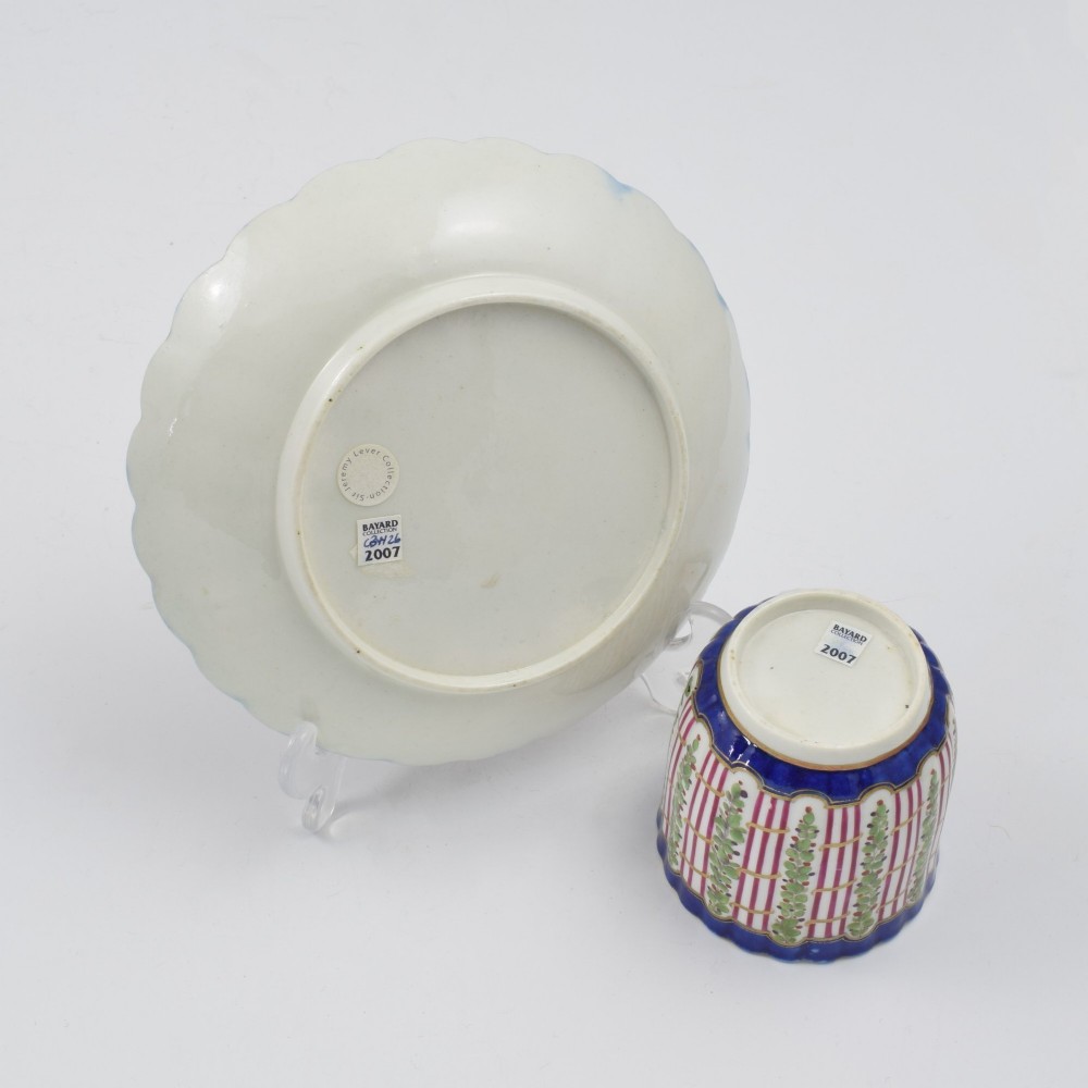 An 18th-century soft-paste porcelain coffee cup and saucer with fluted edges, featuring a cobalt blue border, gilt highlights, and a painted green hop trellis pattern. View VIII
