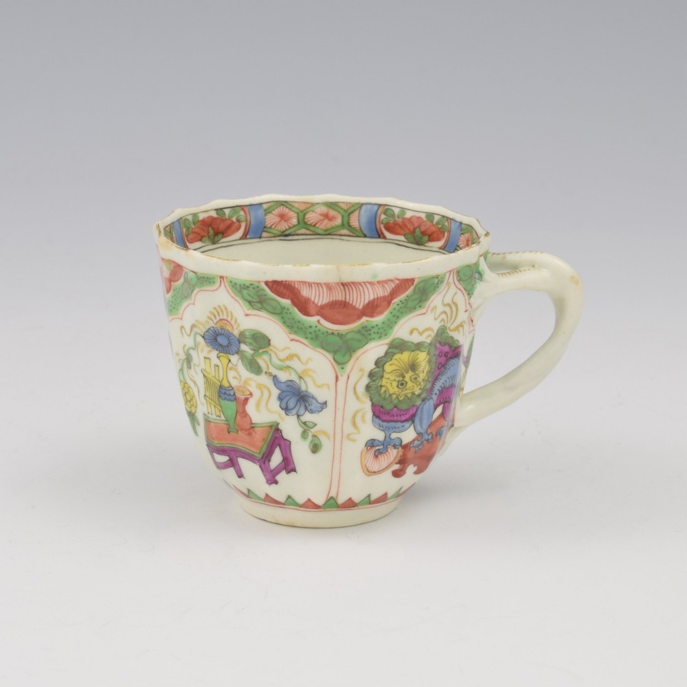 An 18th-century fluted soft-paste porcelain coffee cup with hand-painted Chinoiserie dragon motifs and a looped handle. View III