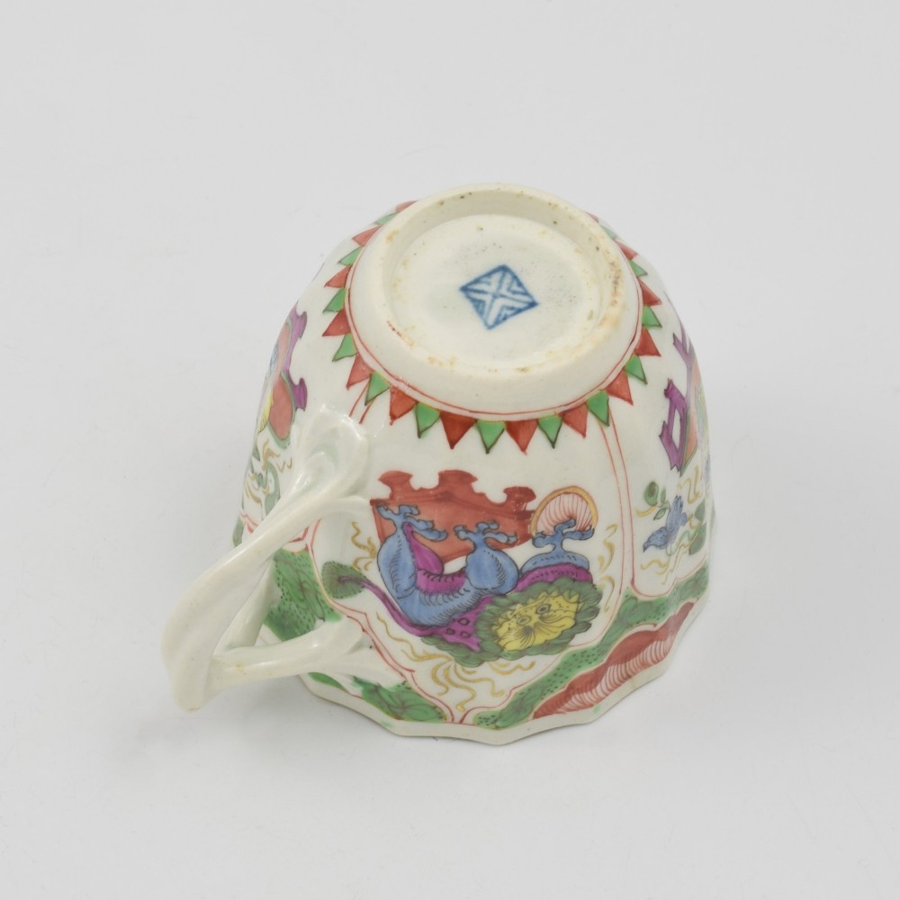 An 18th-century fluted soft-paste porcelain coffee cup with hand-painted Chinoiserie dragon motifs and a looped handle. View VII